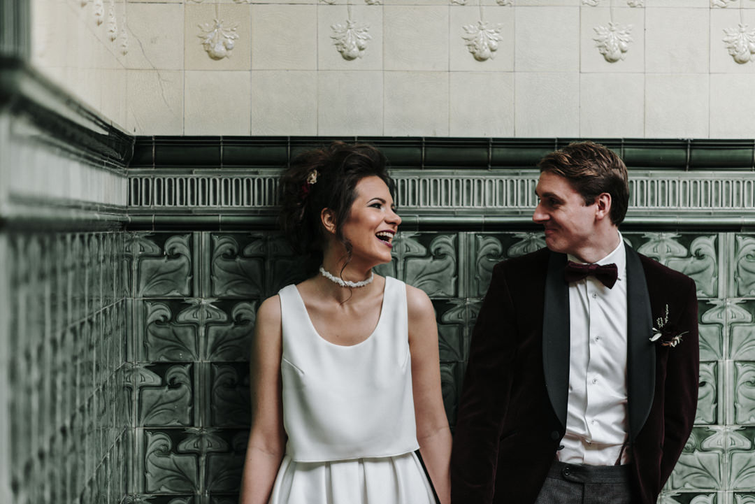 documentary photograph of a laughing bride and groom at Victoria Baths in Manchester